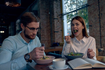 Wall Mural - business man and woman sitting in a cafe snack communication lifestyle