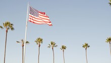 Palms And American Flag, Los Angeles, California USA. Summertime Aesthetic Of Santa Monica Venice Beach. Star-Spangled Banner, Stars And Stripes. Atmosphere Of Patriotism In Hollywood. LA Vibes.