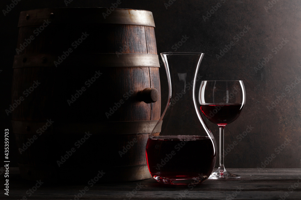 Decanter, red wine and old wooden barrel - obrazy, fototapety, plakaty 