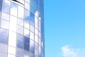 Wall Mural - Architectural detail of the facade with multiple reflections of other buildings and the sun. Modern building. Architecture background