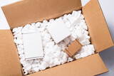 Fototapeta Lawenda - Lot of loose white Filler Shipping Packing Peanuts in cardboard box