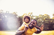 © liderina - African American father and daughter having fun in the park.