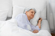 © Syda Productions - old age and people concept - senior woman sleeping in bed at home bedroom