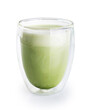Matcha green tea latte in a glass with double walls isolated on a white background.