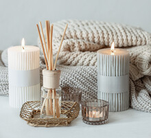 Cozy Home Composition With Candles, Aroma Sticks And A Knitted Element.