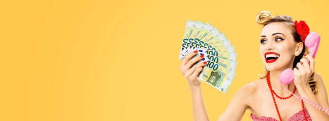 Happy smiling woman with money cash, talking on phone, dressed in pin up style, over orange yellow color background. Caucasian blond girl in retro fashion and vintage concept. Wide composition image.