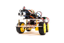 Programmable four wheels drive (4WD) robotic car with obstacle avoidance and line follow ability, isolated on white background with clipping path