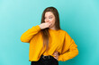 © luismolinero - Teenager girl over isolated blue background doing surprise gesture while looking to the side