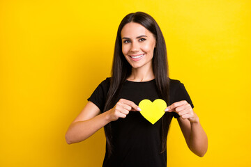 Poster - Photo of pretty positive person hands hold little heart symbol postcard toothy smile isolated on yellow color background