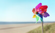Summer beach background, pinwheel or windmill in the sand