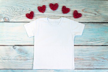 Blank white t-shirt with heart decor, unisex valentine's day apparel mock up. Stock photo.