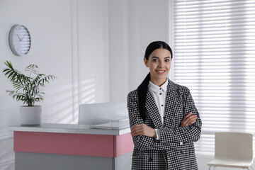 Poster - Portrait of receptionist near countertop in office, space for text