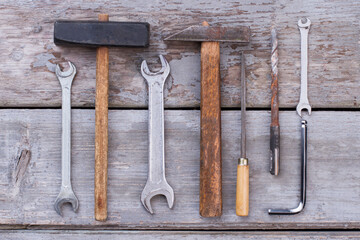 Wall Mural - Set of old construction tools on wooden background.