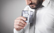 © andranik123 - Man holding a bottle of perfume.