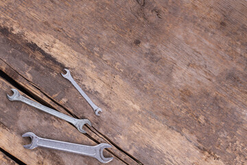 Wall Mural - Wrenches on old wooden boards background.