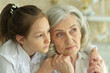 © aletia2011 - Portrait of a sad grandmother and granddaughter hugging