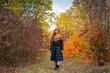 © serejkakovalev - Young woman with red dreadlocks and wearing a sweater in the beautiful autumn forest