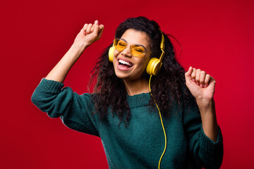 Sticker - Photo of shiny adorable dark skin woman dressed green pullover headphones glasses dancing singing isolated red color background