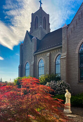  Church and steeple with cross and saint. Francis statue.