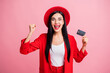 © deagreez - Photo portrait of crazy celebrating woman holding credit card in one hand isolated on pastel pink colored background