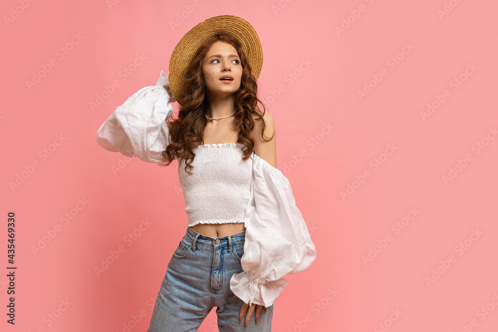 Fashion studio photo of elegant red haired girl in straw hat and summer ...