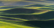 View of Farmland rolling hill with dramatic sunset light from Steptoe Butte State Park in Washington