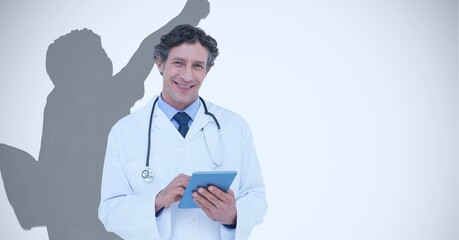 Wall Mural - Composition of smiling male doctor and male athlete shadow with copy space on white