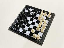 High Angle View Of Travel Chess Set On A Light Background