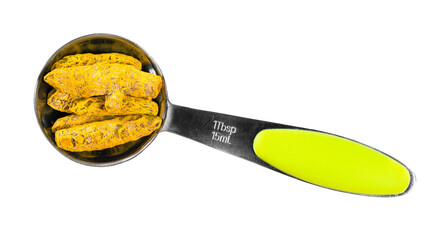 Wall Mural - dried roots of turmeric in measuring spoon cutout