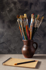 Sticker - Paint brush and artist tools on table background texture. Paintbrush and art still life