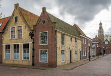 Historical Buildings In Dutch City Enkhuizen With Tower Of Zuiderkerk Church