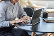 © amnaj - Close up of a businesswoman sitting at the office using a tablet.
