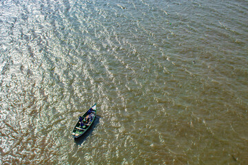 Wall Mural - fishing boat in the green sea