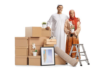 Sticker - Young muslim couple packing for removal with a pile of cardboard boxes