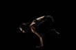 © Nikola Spasenoski - cute caucasian girl exercising yoga poses against dark backgroung. side lit silhouette.