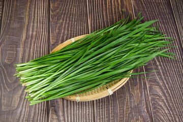 Wall Mural - Fresh Chinese chives,Garlic chives on wooden background