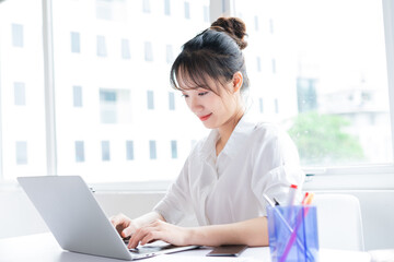 portrait of happy and working young businesswoman