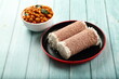 Homemade delicious steamed red rice puttu served with chickpeas curry, Kerala foods background.