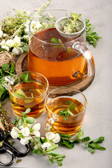 Wall Mural - Herbal tea with cups and teapot on light gray backround.