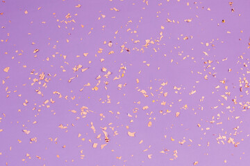 Wall Mural - Falling gold confetti on purple background. Backdrop for parties, celebration an Birthdays.