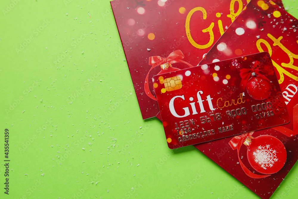 Gift cards on color background, closeup