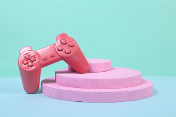 Wall Mural - Pink gamepad on pink podium. Tournament and victory. Concept art. Creative layout. Minimalism