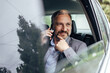 © bnenin - Adult man calling his office, going there by car.
