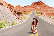 Beautiful Young Girl In A Denim Skirt On A Scenic Road In Valley Of Fire, Nevada
