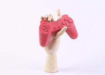 Wall Mural - Wooden hand holding gamepad on white background