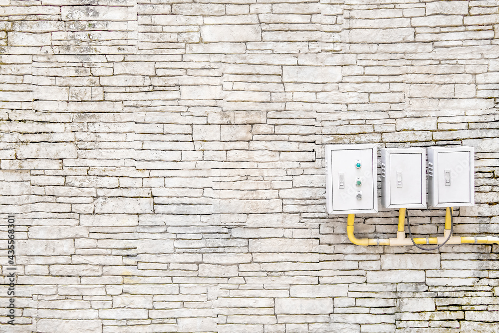 Photo Stock ฺBrick wall and electric control box with yellow pipe ...