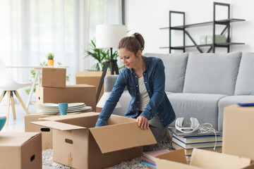 Wall Mural - Woman unpacking in her new apartment