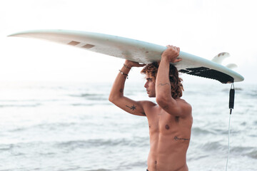 Sticker - Young caucasian man get up early to  doing surf at sunrise