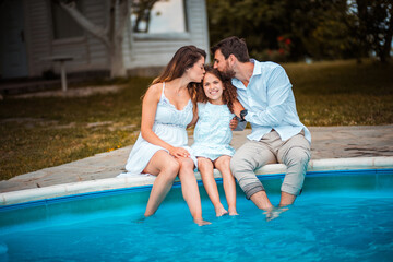 Wall Mural - Family sitting by the pool