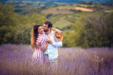 Young couple having fun on lavender field.